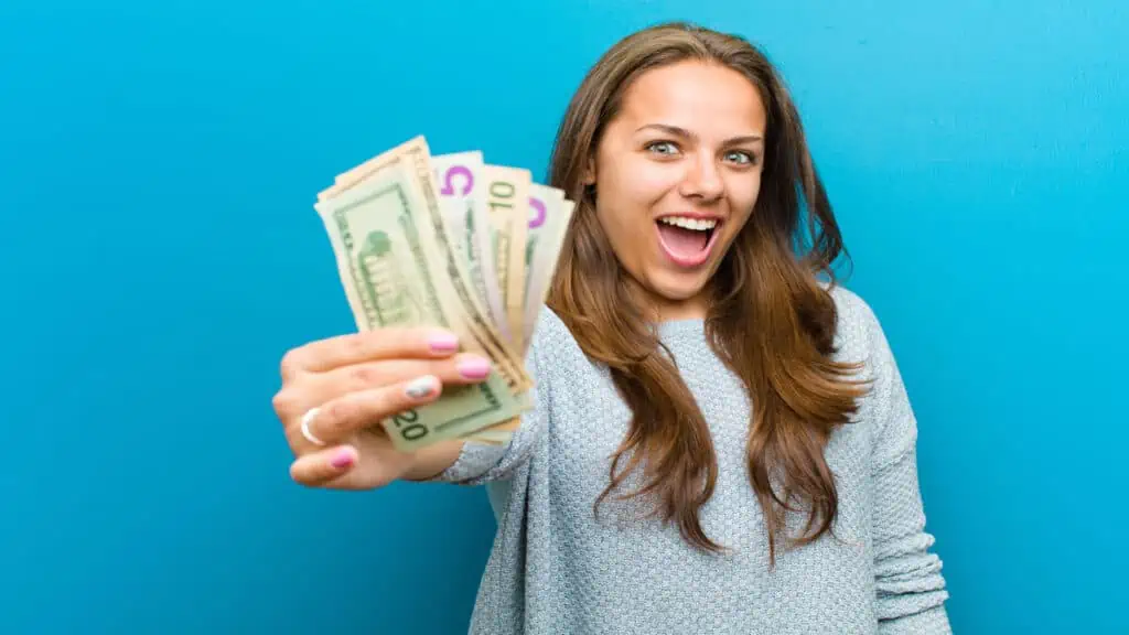 woman holding cash saying i need money now