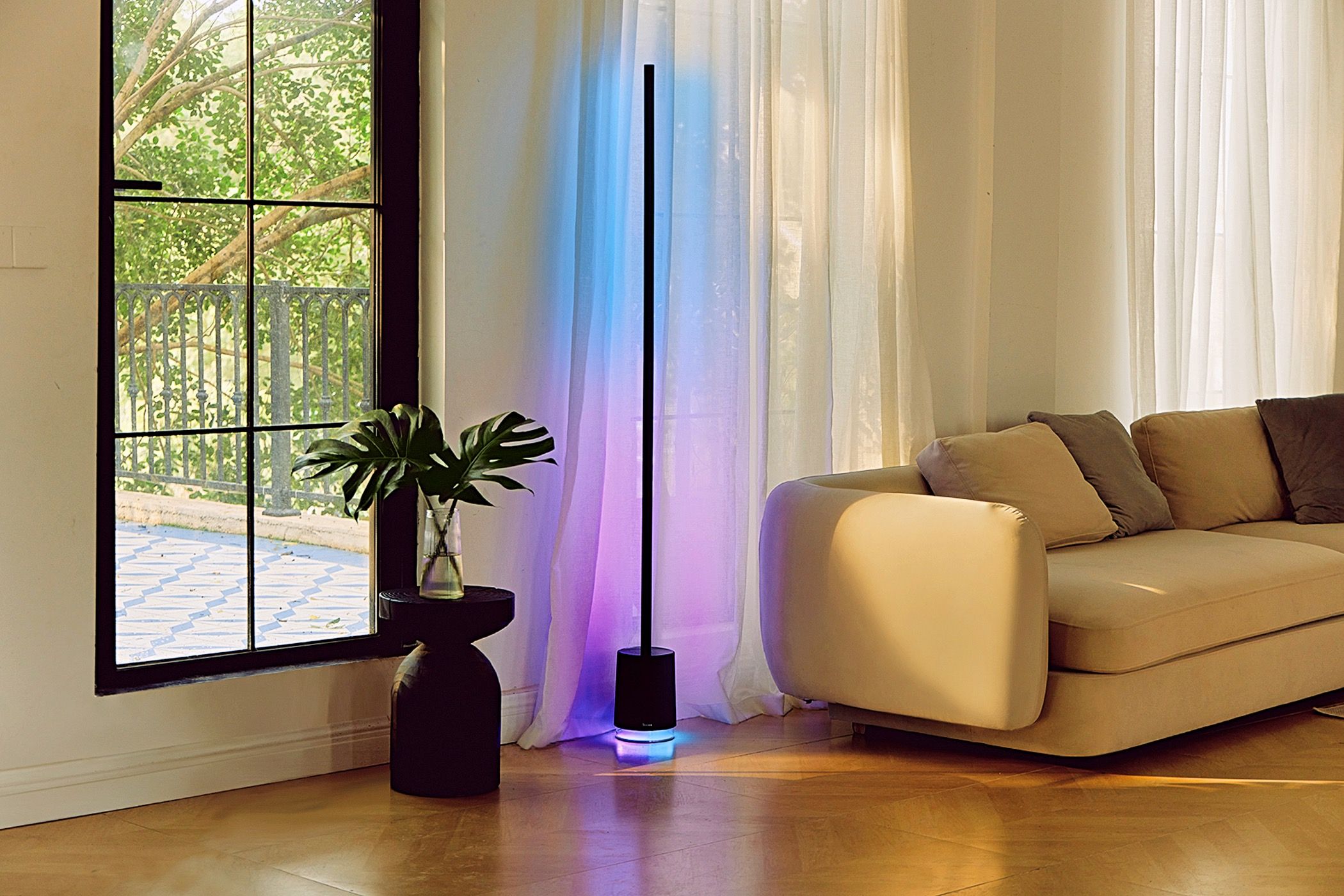 A Govee floor lamp located next to a couch in a living area.