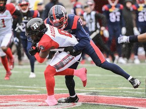 Montreal Alouettes' Tyrice Beverette, right, tackles Ottawa Redblacks' Bralon Addison.