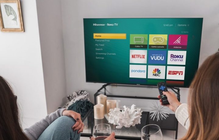 Hisense R6 Series 4K TV with remotes pointed at it.