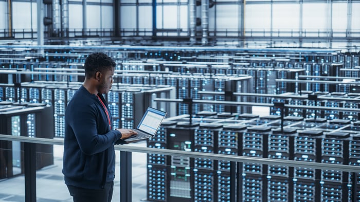 An IT professional in a server room.