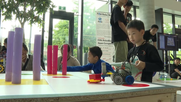 child plays with robotic toys