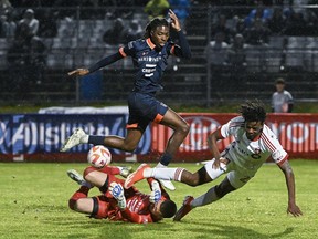 CS Saint-Laurent goalkeeper Konstantinos Maniatis, bottom left, stops Toronto FC forward Deandre Kerr, right, as Saint-Laurent's Cedrick Adamou defends during second half Canadian Championship quarterfinal soccer action in Montreal.