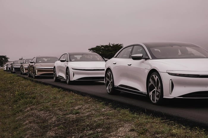 A photo of several Lucid Air vehicles lined up on the road.