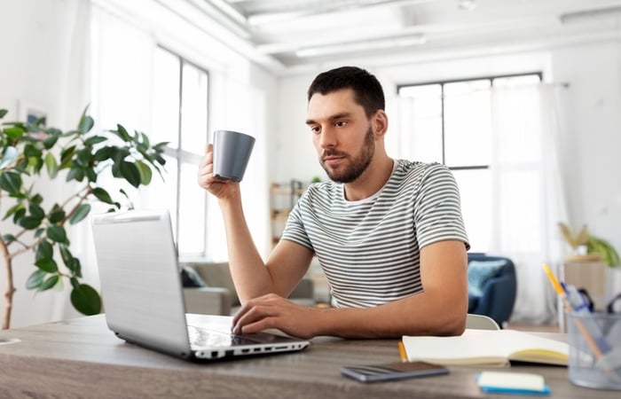 Young, inexperienced investor picking his first investment in an exchange-traded fund.