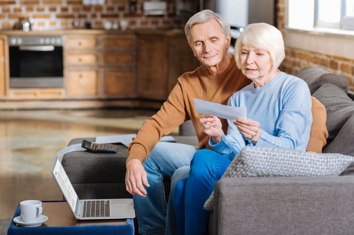 Older couple looking at a check.