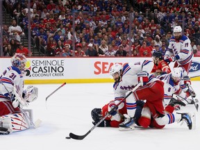 Evan Rodrigues of the Florida Panthers lies on the ice after being hit by Jacob Trouba, #8 of the New York Rangers (centre right) during second period play in Game 3 of the NHL Eastern Conference final on Sunday in Sunrise, Fla.