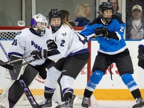 Toronto's Natalie Spooner (24) battles for position with Minnesota's Lee Stecklein (2) in front of goaltender Maddie Rooney during the third period in Toronto on Wednesday May 1, 2024.