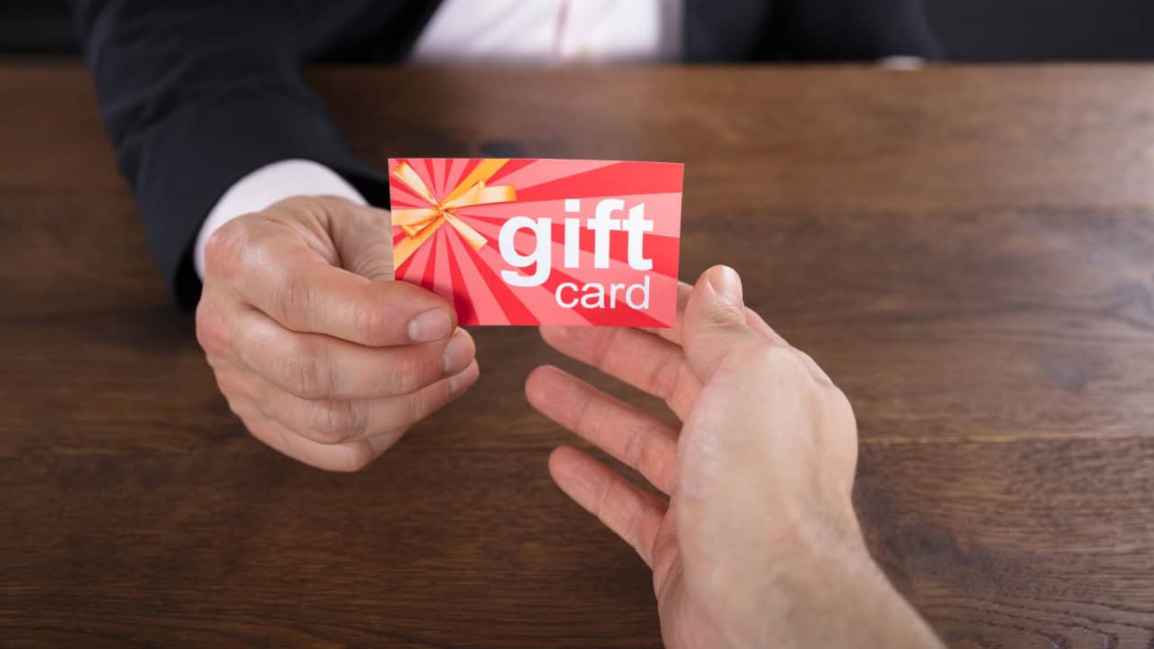 Male hand giving Gift Card