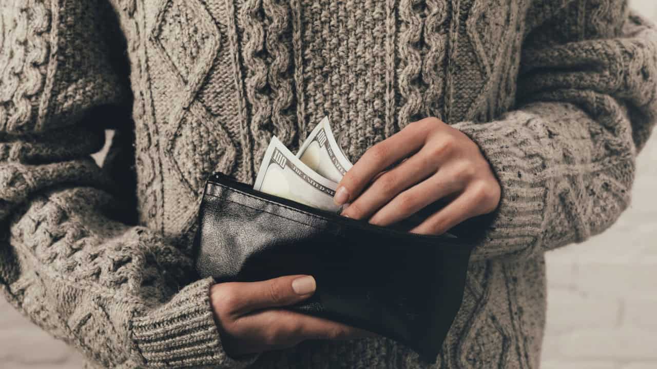 Woman holding wallet with cash