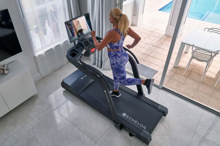 Woman running on a Echelon Stride Sport Auto-Fold Compact Treadmill.