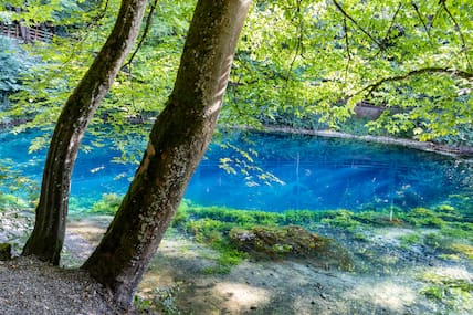 Blick auf den Blautopf mit seinem leuchten blauen Wasser.