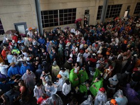 Fans wait for the rain to stop as the start is delayed for the 108th Running of the Indianapolis 500 at Indianapolis Motor Speedway on May 26, 2024 in Indianapolis, Ind.