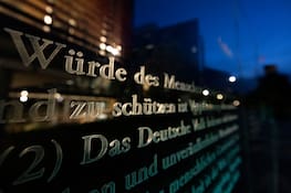 BERLIN, GERMANY - MAY 07: The text of Germany's Basic Law, the Grundgesetz is etched into glass panels near the Reichstag on May 07, 2024 in Berlin, Germany. Germany will celebrate the 75th anniversary of the Basic Law in coming weeks. The Basic Law is modern Germany's version of a constitution and serves as the legal basis for its political system and the guarantee of fundamental individual rights and freedom. The glass panels are the creation of Israeli artist Dani Karavan. (Photo by Maja Hitij/Getty Images)