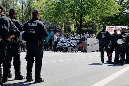 Einsatzkräfte der Hamburger Polizei beobachtet die Teilnehmer bei einer Demonstration linker Gruppen zum 1. Mai im Schanzenviertel.