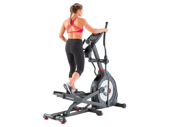 A woman works out on the Schwinn 470 Compact Elliptical Machine.