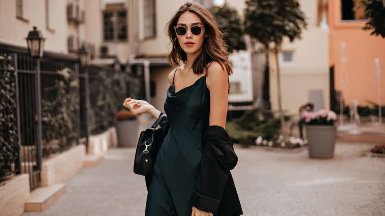 Fashionable pale brunette in long green dress