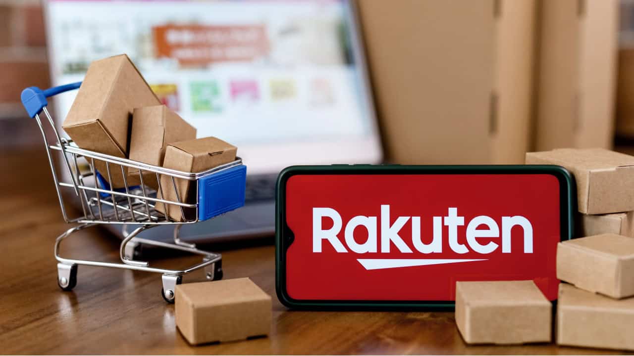 Smartphone with Rakuten logo on the screen, shopping cart and laptop