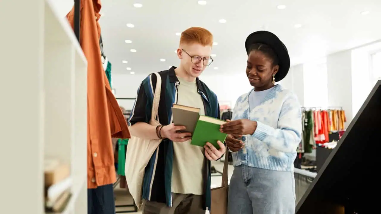 young people looking at used books in thrifting shop or swap event