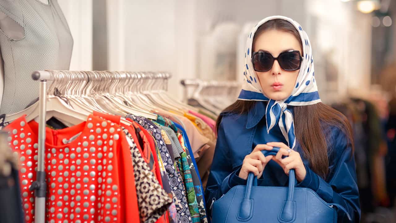 Curious Girl in Blue Trench Coat and Sunglasses Shopping