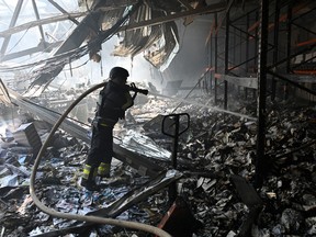 A Ukrainian rescuer works at the site of a missile attack