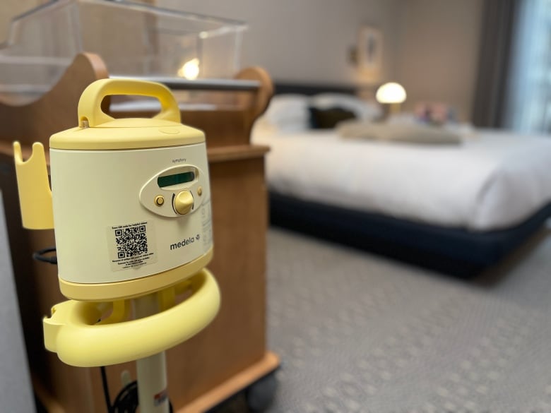 A breast pump is pictured next to a bassinet.