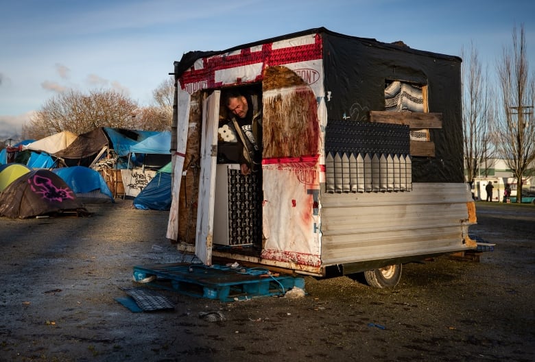 Doug Ehret steps out of his trailer at a homeless encampment at Strathcona Park, in Vancouver, on Tuesday, December 22, 2020.