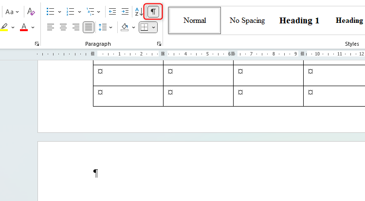 A Word document with an empty paragraph marker after table, taking the document to a new page. The Show/Hide icon is also highlighted at the top of the image.