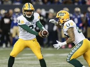 Edmonton Elks quarterback Tre Ford (2) hands off to Shannon Brooks (22) during second half CFL action against the Winnipeg Blue Bombers in Winnipeg, Saturday, Oct. 21, 2023.