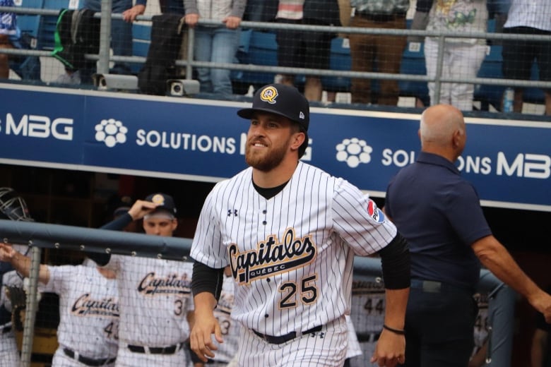 A baseball player runs onto the field