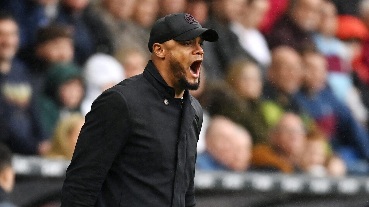 Burnley manager Vincent Kompany wearing a cap, shouting.