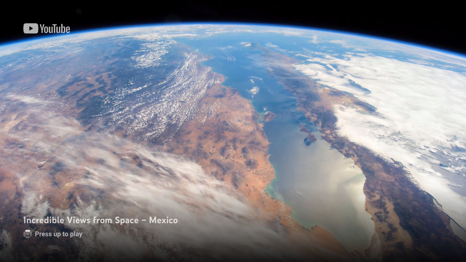 The YouTube screensaver on Apple TV showing ISS views of Earth from space.