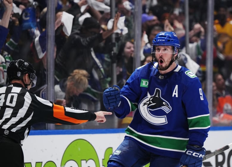 A hockey player celebrates after scoring a goal.