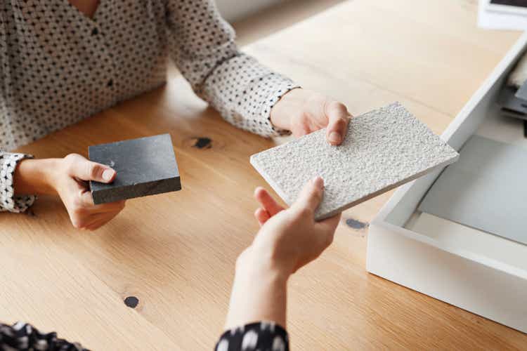 Businesswomen holding samples over table in office