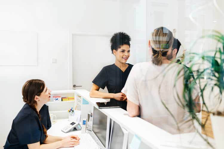 Staff Talking Amongst Each Other In Dental Practice