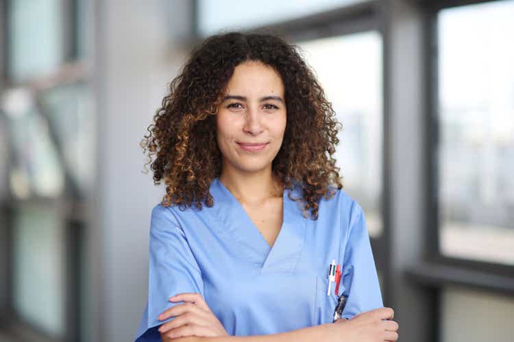 A nurse posing in a hospital corridor