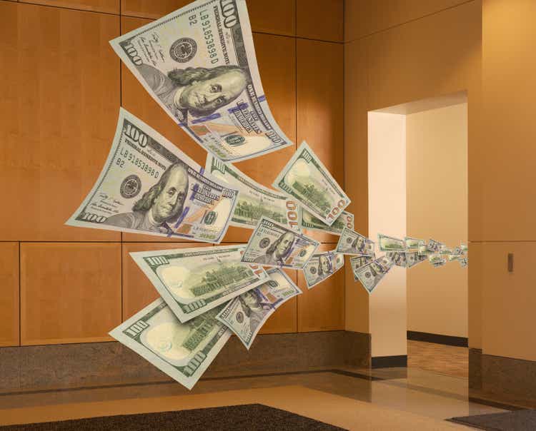 Cash flowing through office doorway