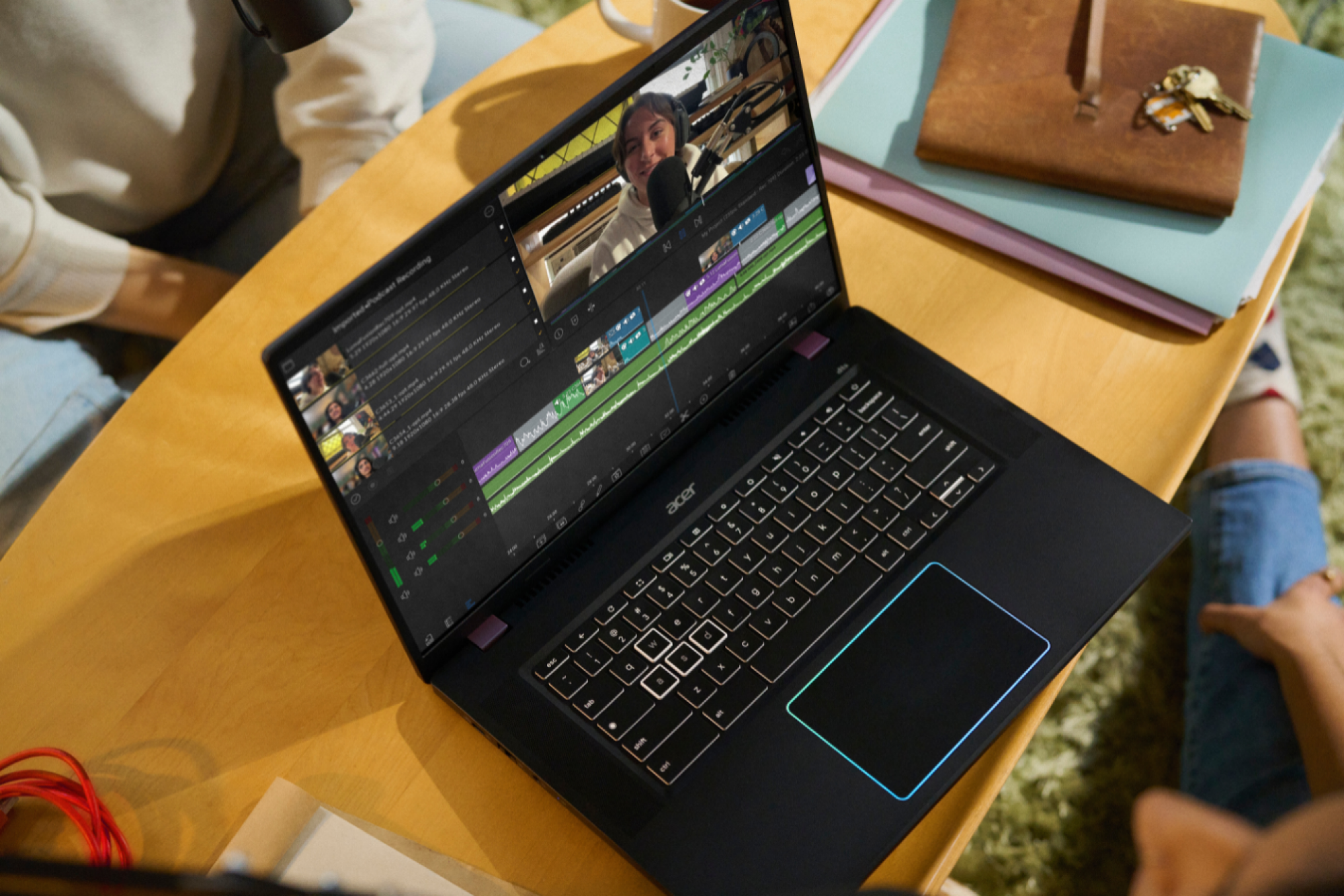 a top-down view of someone using the Acer Chromebook Plus 516 GE to edit a podcast on a wooden surface