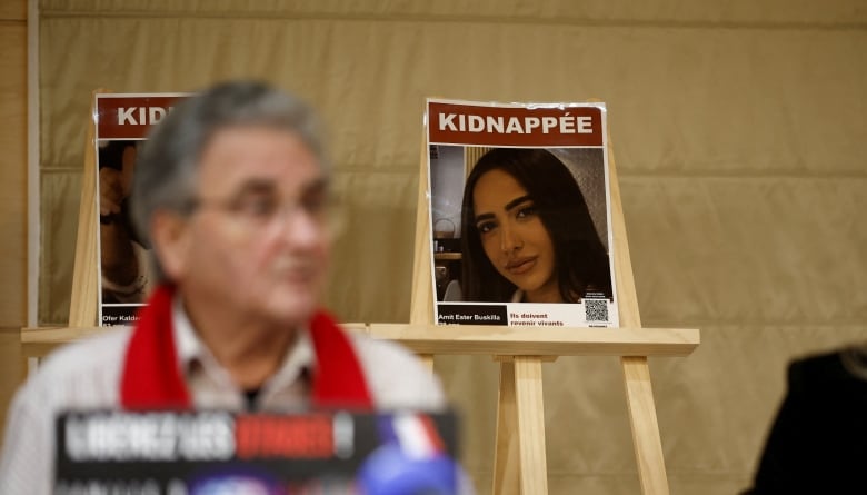 A woman's photo under the word "KIDNAPPED" is seen on an easel at a news conference.