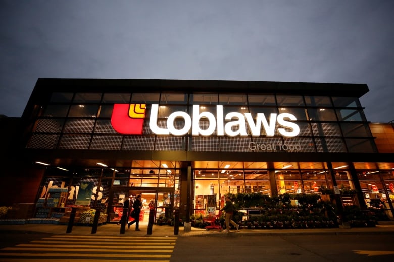 A loblaws  store pictured from the parking lot in the evening