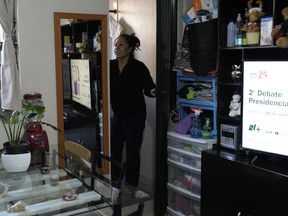 A television program promotes an upcoming presidential debate as domestic worker Concepcion Alejo goes through her morning routine, in her apartment in Mexico City, Wednesday, April 24, 2024.