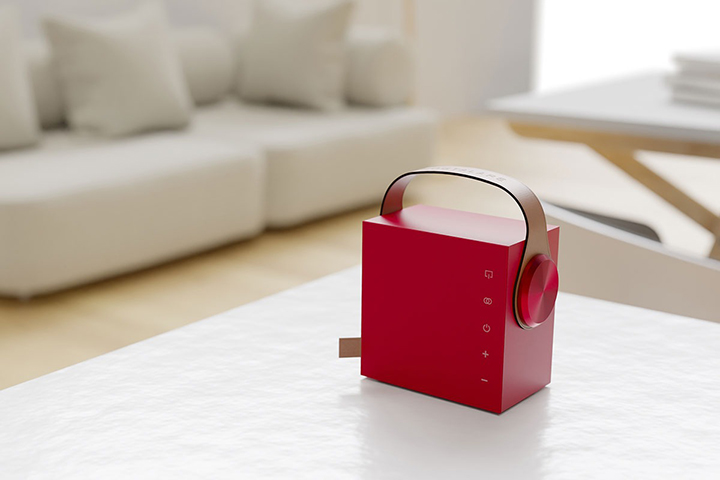 Morel Audio BIGGIE in the Ruby Red finish, sitting atop a coffee table.