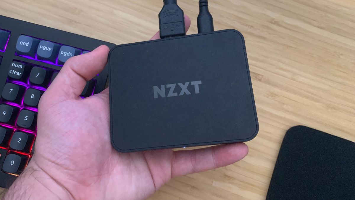 NZXT Signal 4K30 capture card held in hand over desk