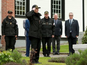 Princess Anne salutes after laying a commemorative wreath