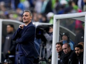 Vancouver Whitecaps head coach Vanni Sartini looks on from the sideline against the Seattle Sounders during the first half of an MLS soccer match Saturday, April 20, 2024, in Seattle.