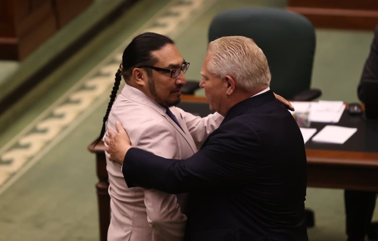 NDP MPP Sol Mamakwa and Ontario's Progressive Conservative Premier Doug Ford embrace each other in the provincial legislature.