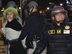 Police make an arrest as they face-off with pro-Palestinian students after destroying part of the encampment barricade on the campus of the University of California, Los Angeles (UCLA) in Los Angeles, California, early on May 2, 2024.