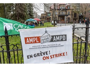 A sign on a fence on the McGill campus shows that the Association of McGill Professors of Law are on strike.