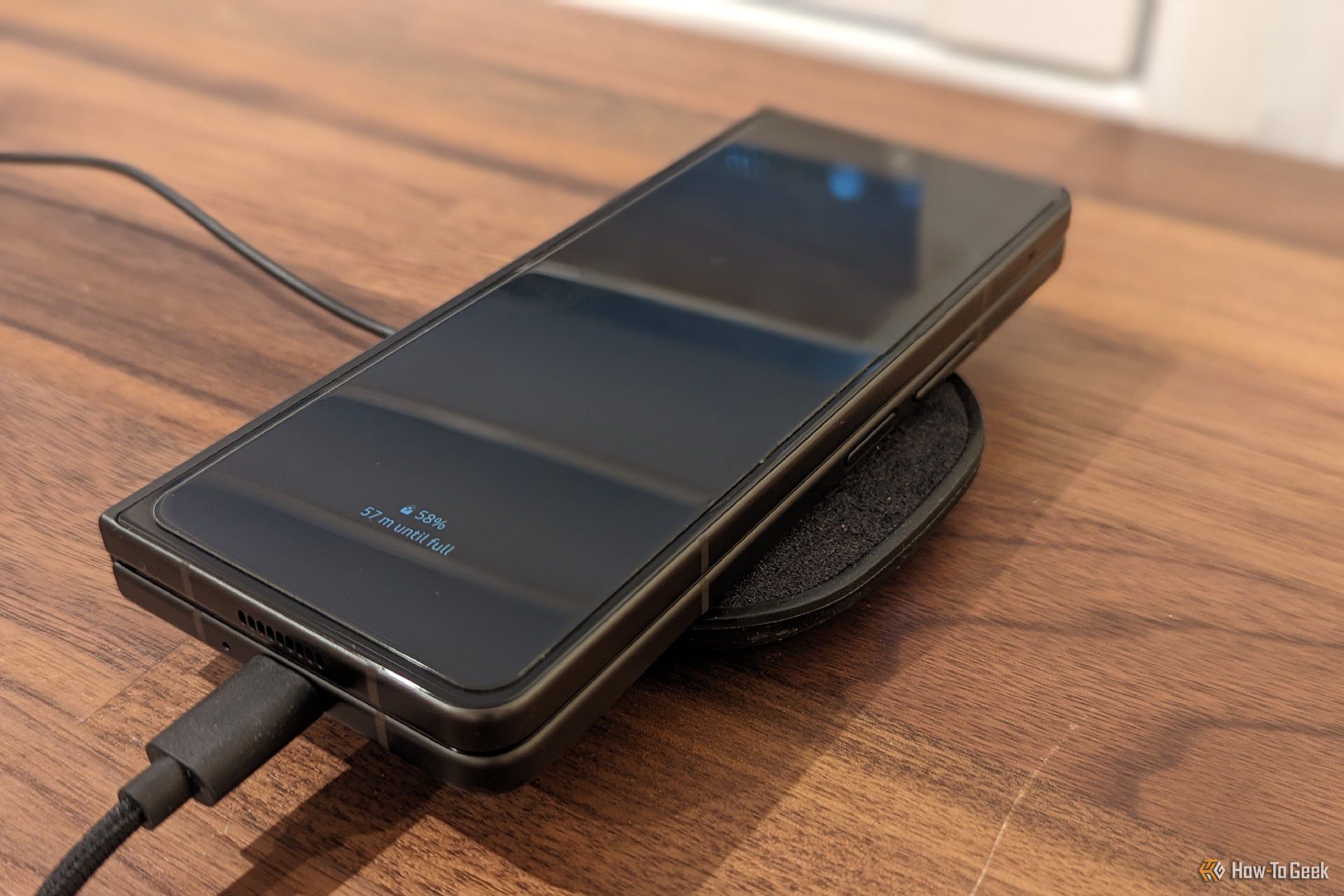 Galaxy Z Fold 5 on a wireless charger with AR glasses plugged in