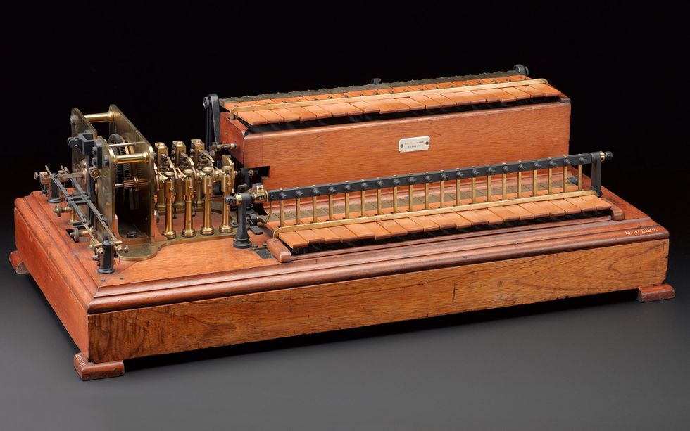 Photo of a rectangular scientific instrument made of wood and brass. 